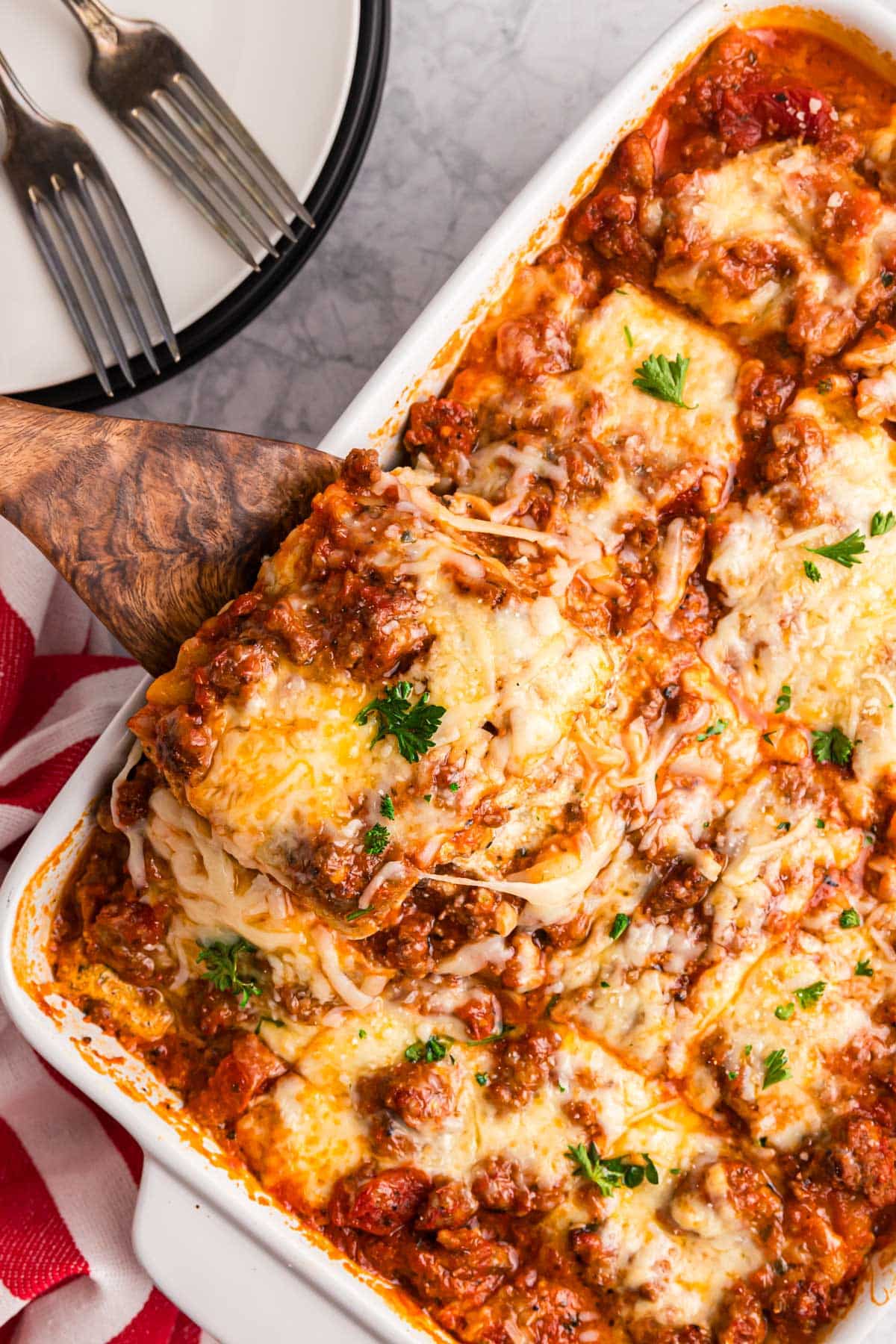 overhead view of a spatula pulling out a piece of lasagna