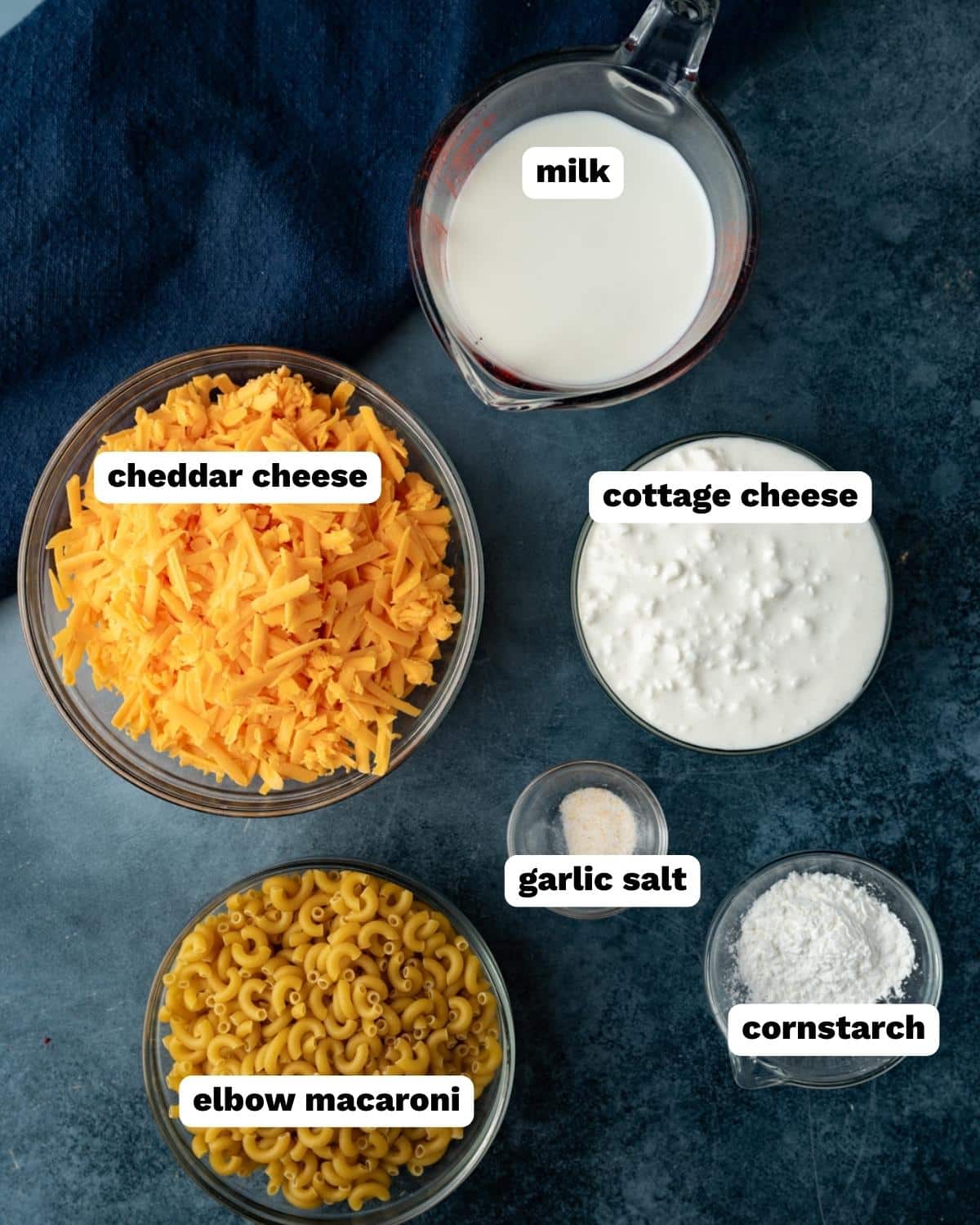 ingredients for macaroni and cheese with cottage cheese on a table