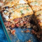 taco lasagna with flour tortillas in a casserole dish