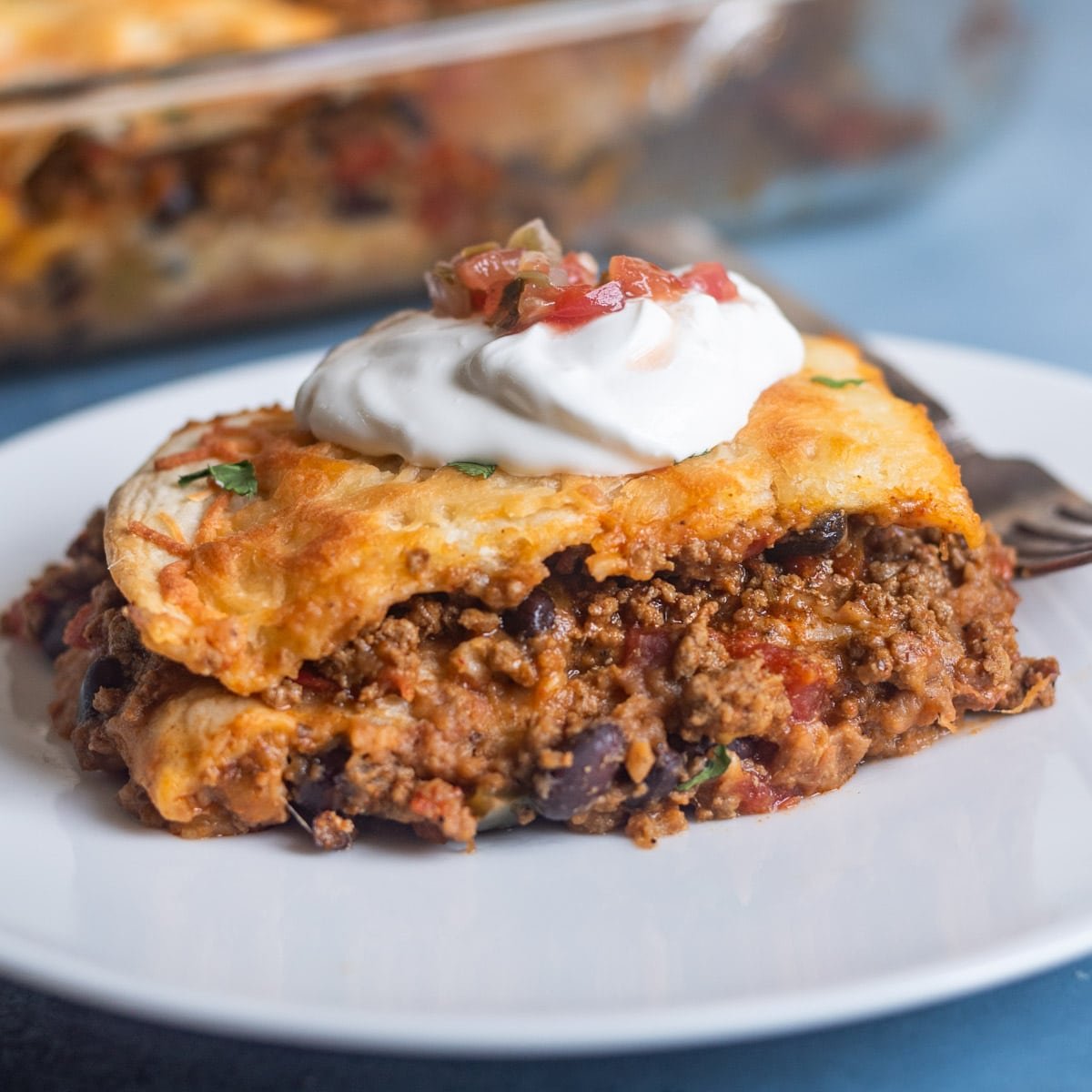 a piece of taco lasagna sitting on a plate