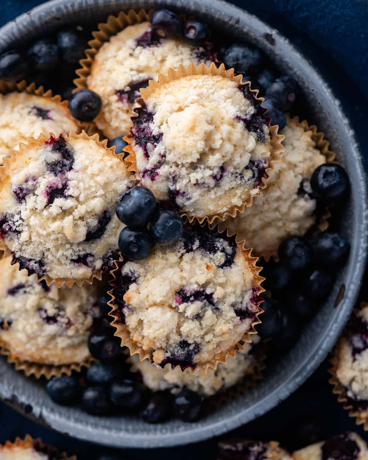 a pan of blueberry muffins with streusel topping