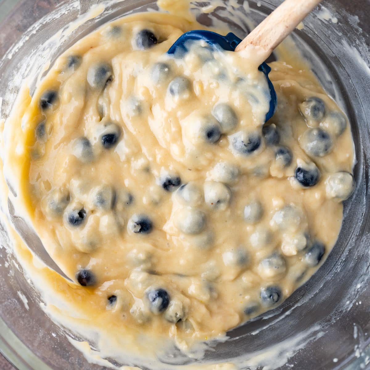 blueberry muffin batter in a bowl with a spatula