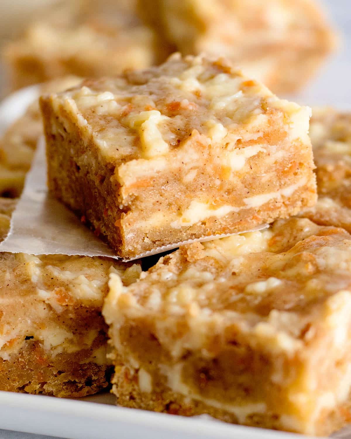 cream cheese carrot cake bars on a table
