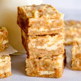 a stack of 3 carrot cake bars on a table