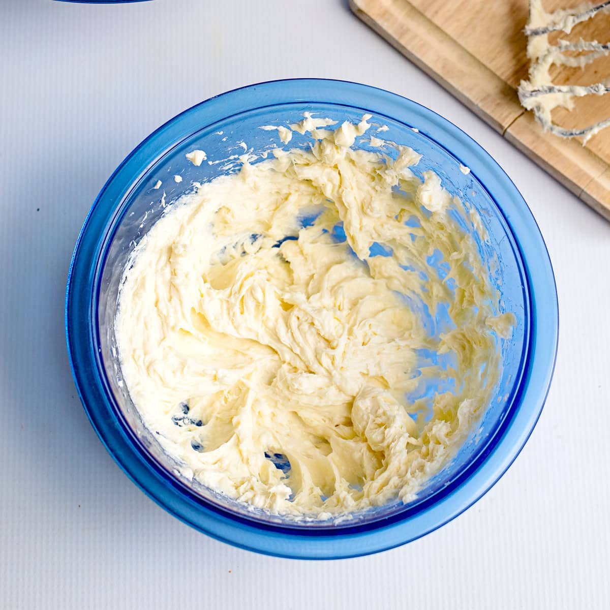 cheesecake filling in a blue mixing bowl
