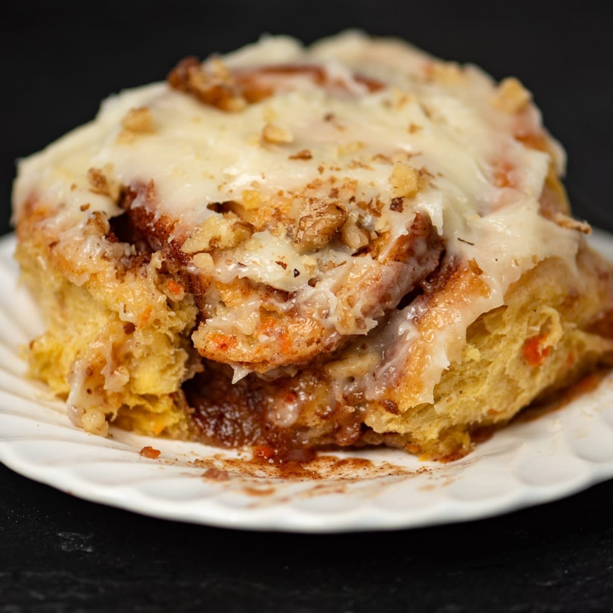 closeup of a cinnamon roll with a bite out