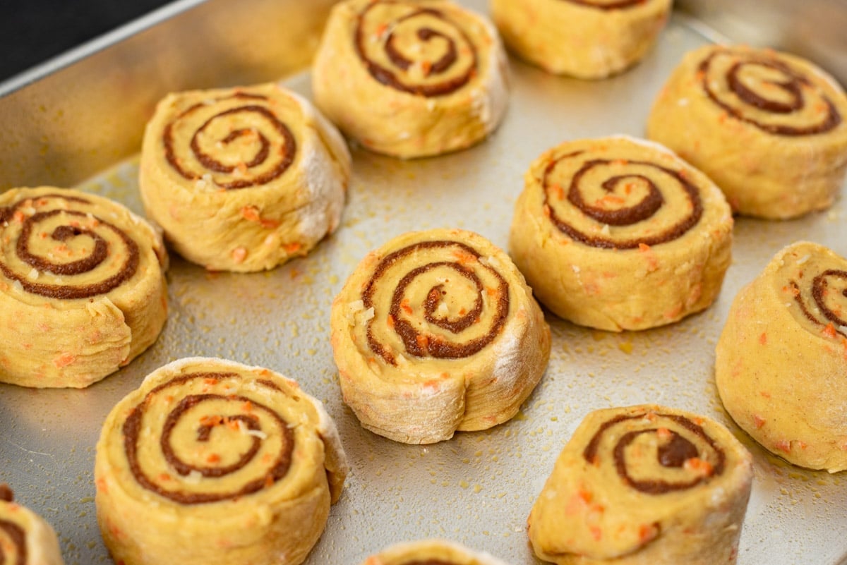 unbaked carrot cake cinnamon rolls in a pan
