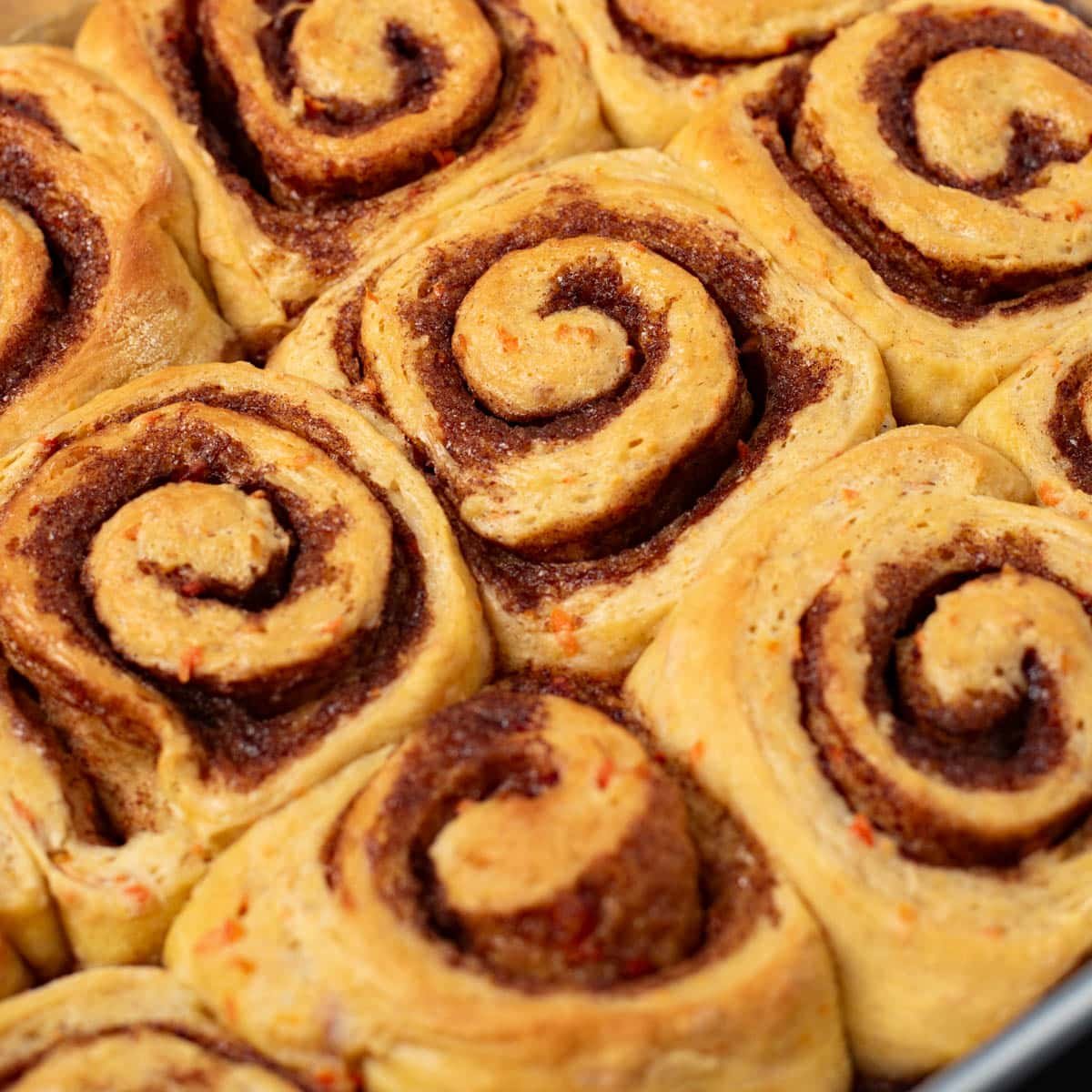 carrot cake cinnamon rolls in a pan