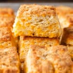 two cheddar biscuits with garlic butter stacked on them