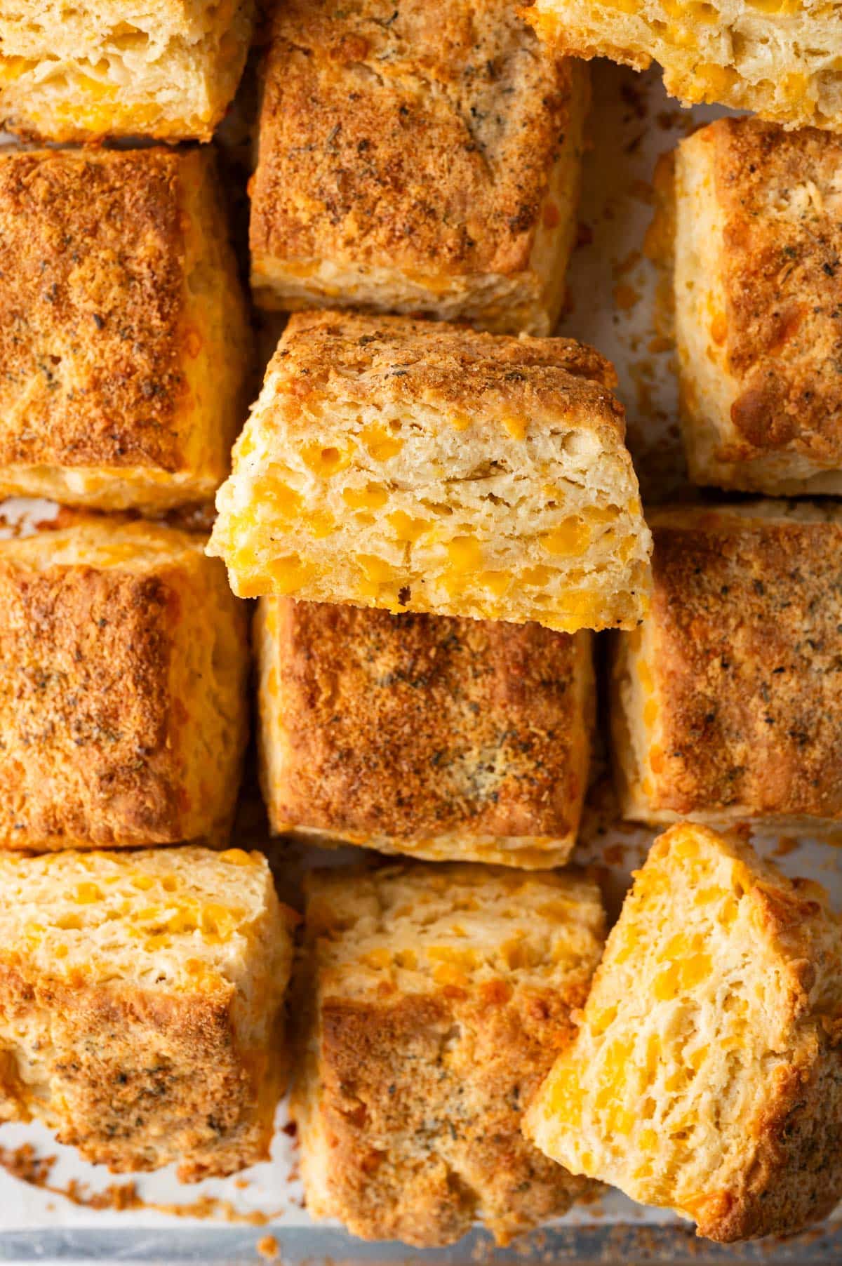 overhead view of square cheddar biscuits on a baking sheet