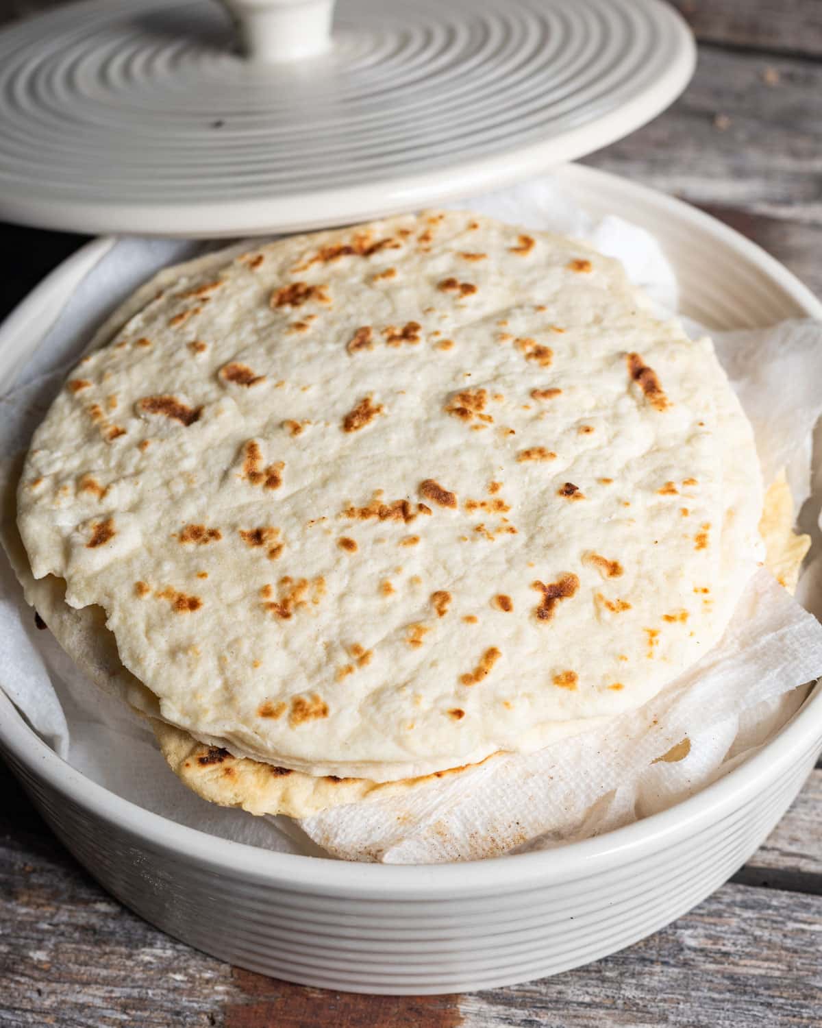 a stack of flour tortillas in a tortilla warmer