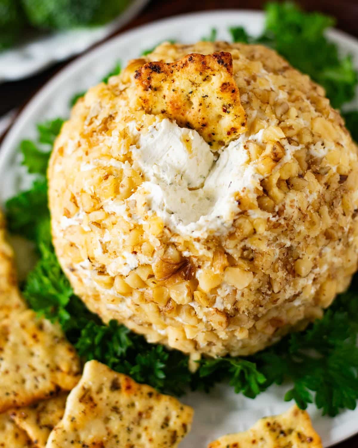 a cracker sitting on top of a garlic cheese ball
