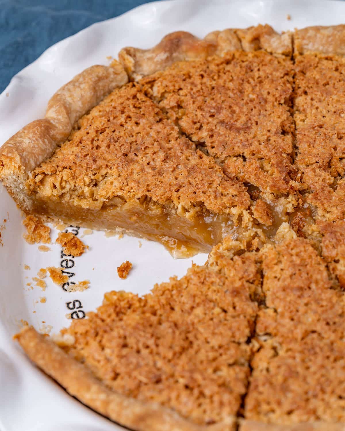 an amish oatmeal pie in a pie plate with one piece missing