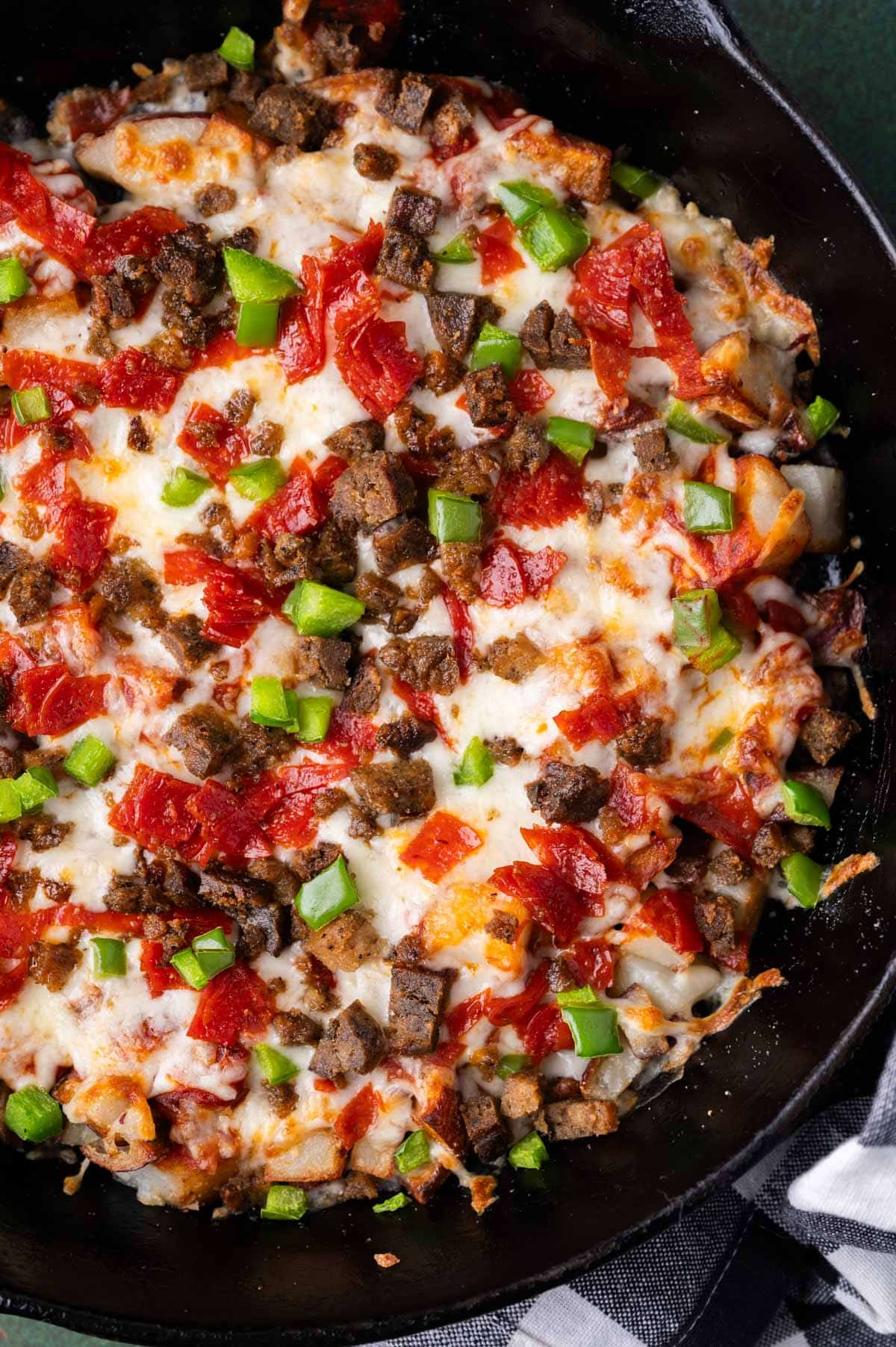 pizza potatoes with toppings in cast iron skillet