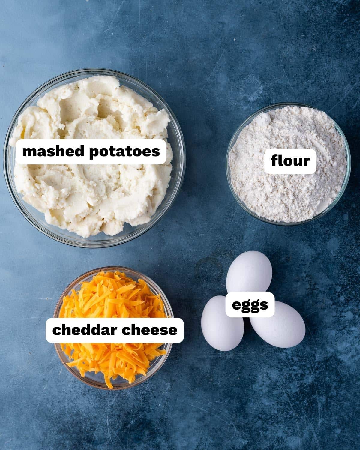 ingredients for mashed potato cakes on a table