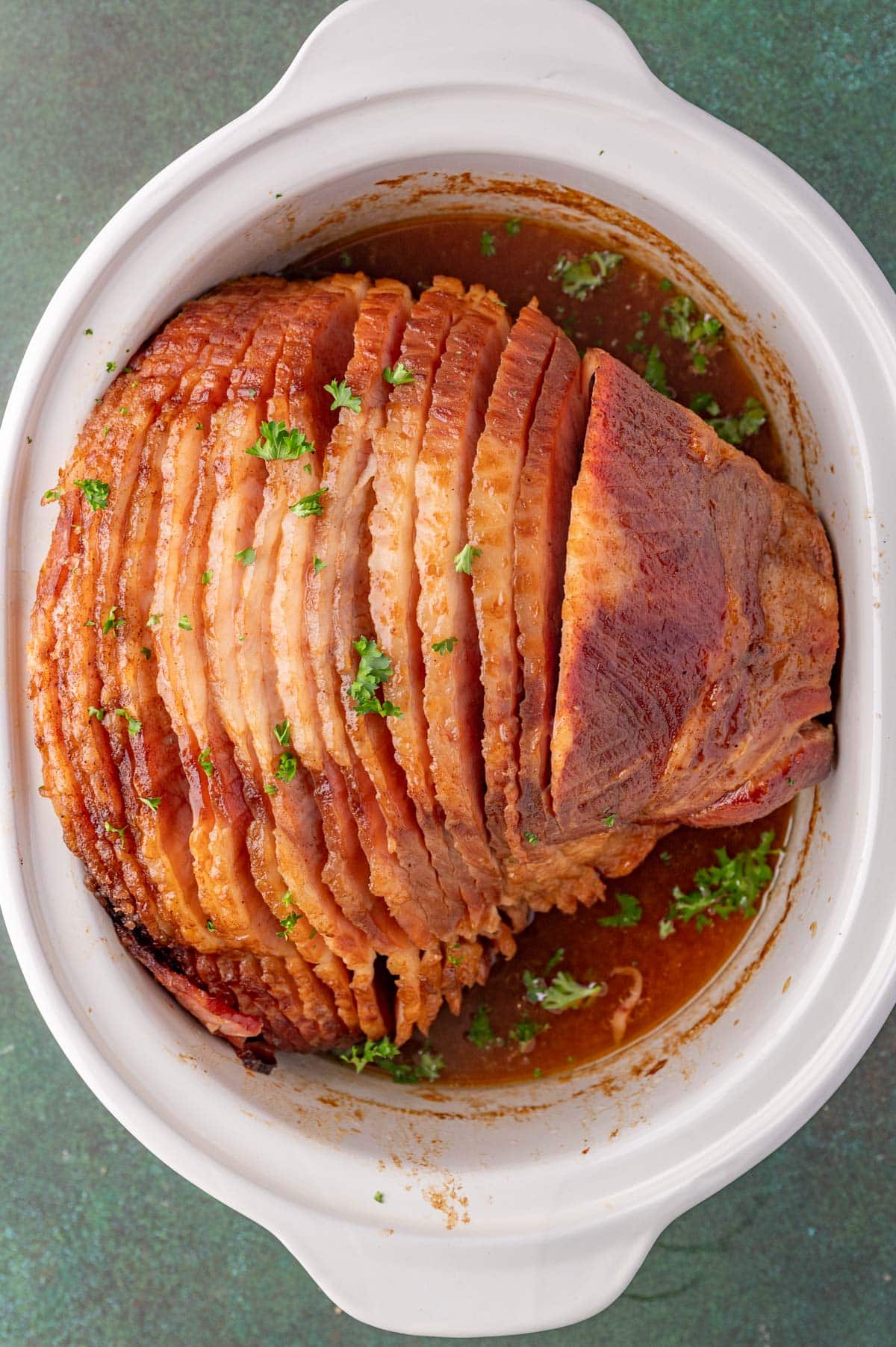 overhead view of spiral cut ham in a slow cooker