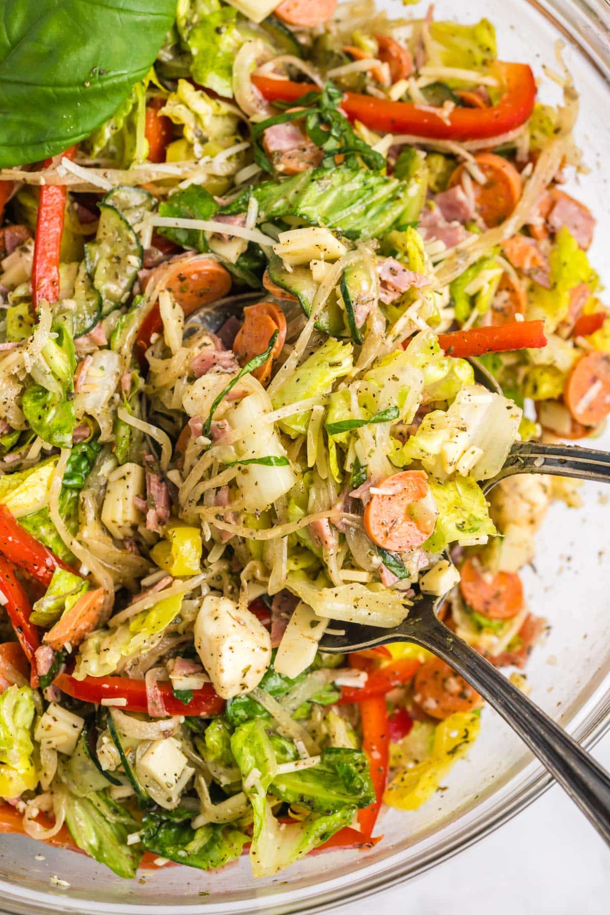 closeup of italian sub salad in a bowl with forks