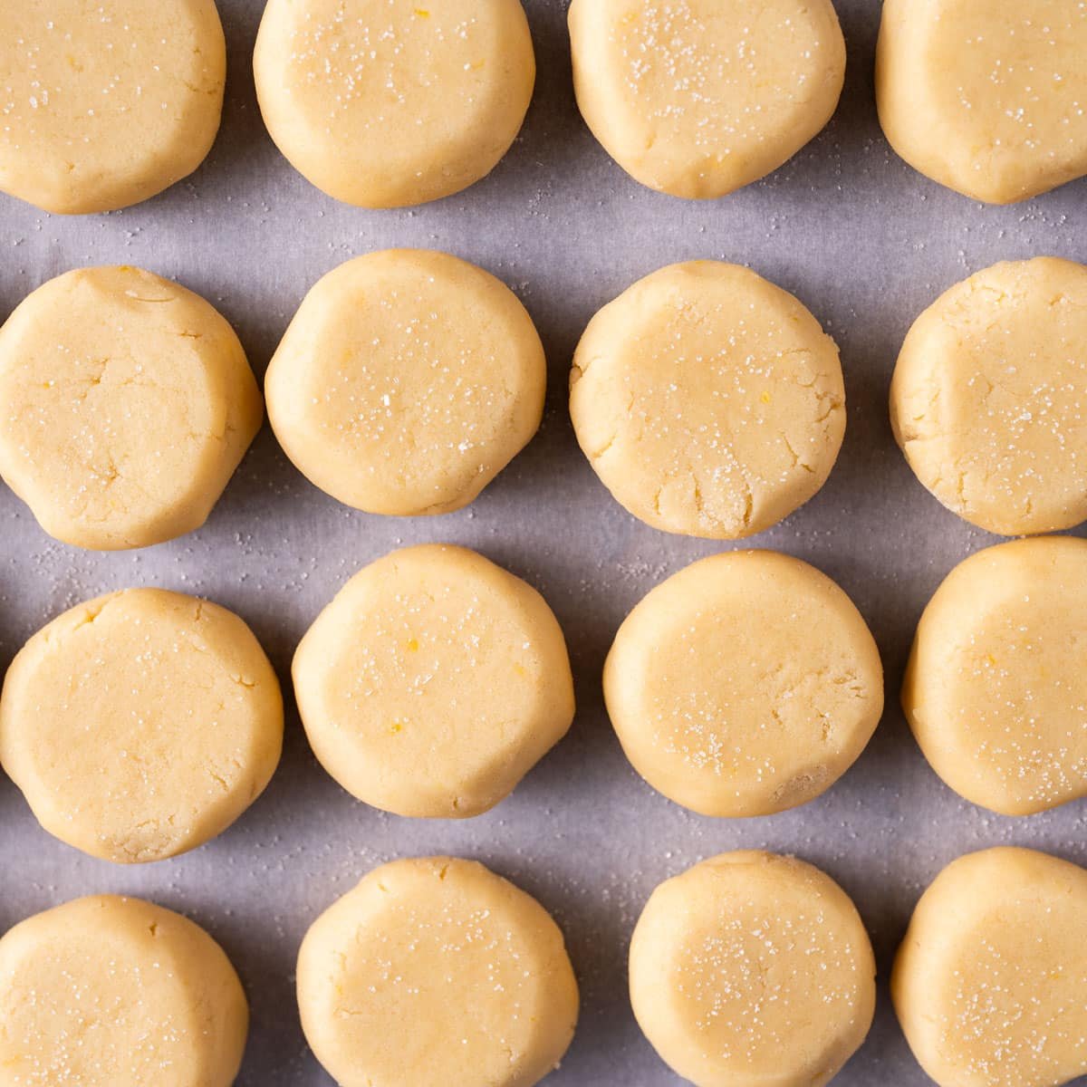unbaked cookie dough balls on a baking sheet