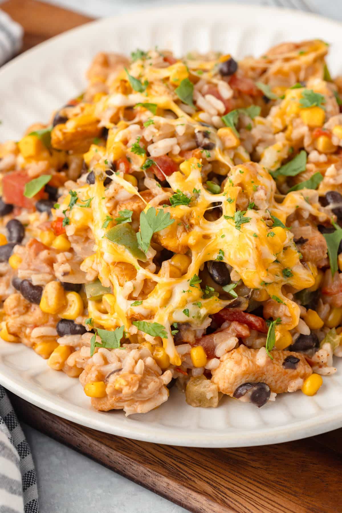 mexican chicken and rice on a plate with melted cheese and fresh cilantro