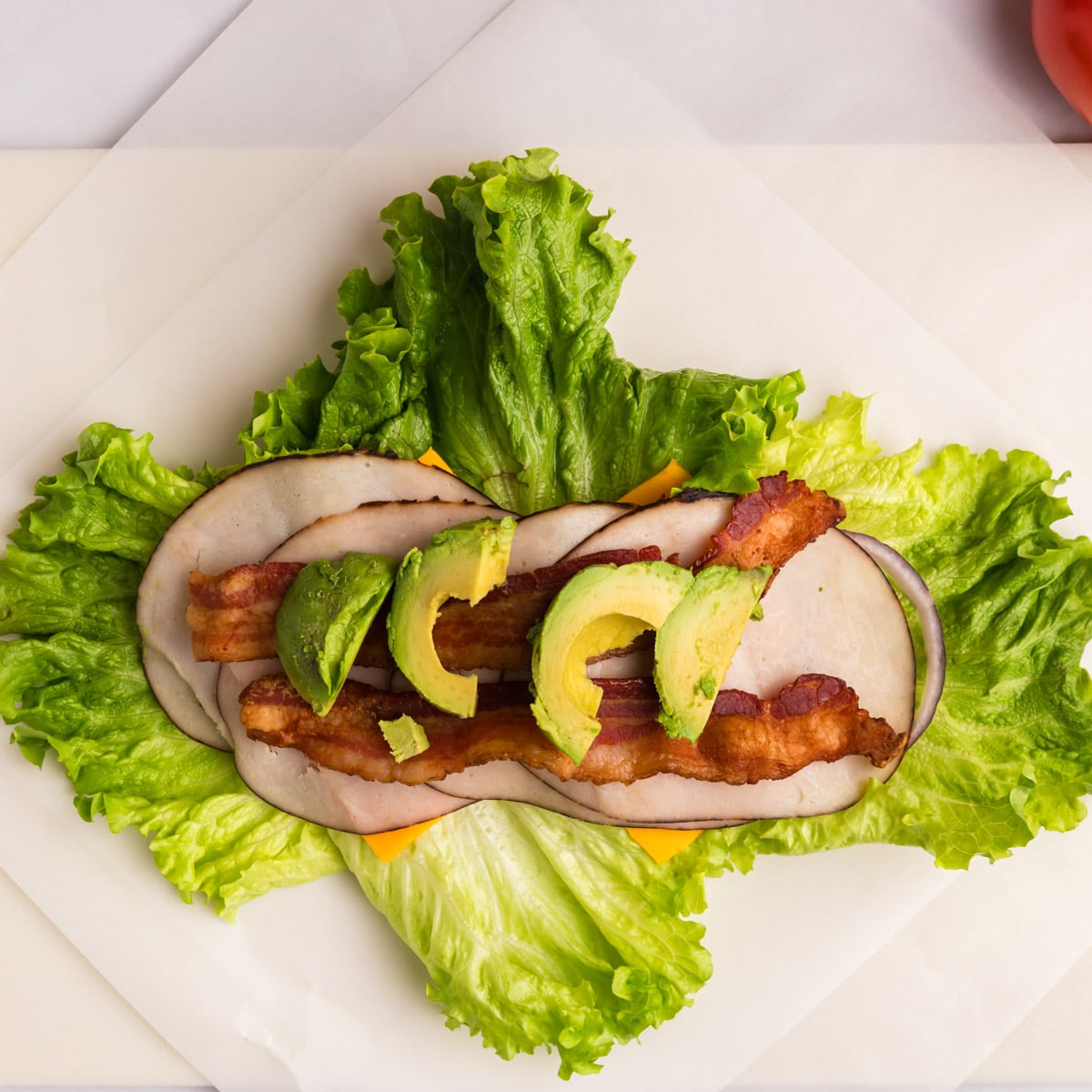 lettuce layered with turkey, bacon and avocado