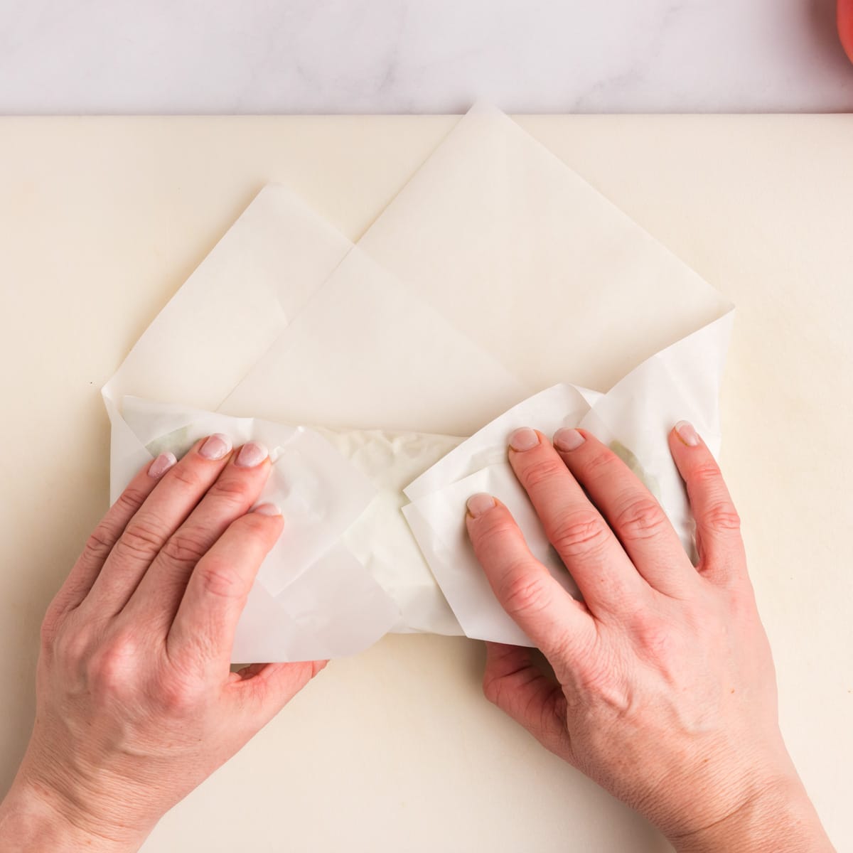 folding a lettuce wrap in parchment paper