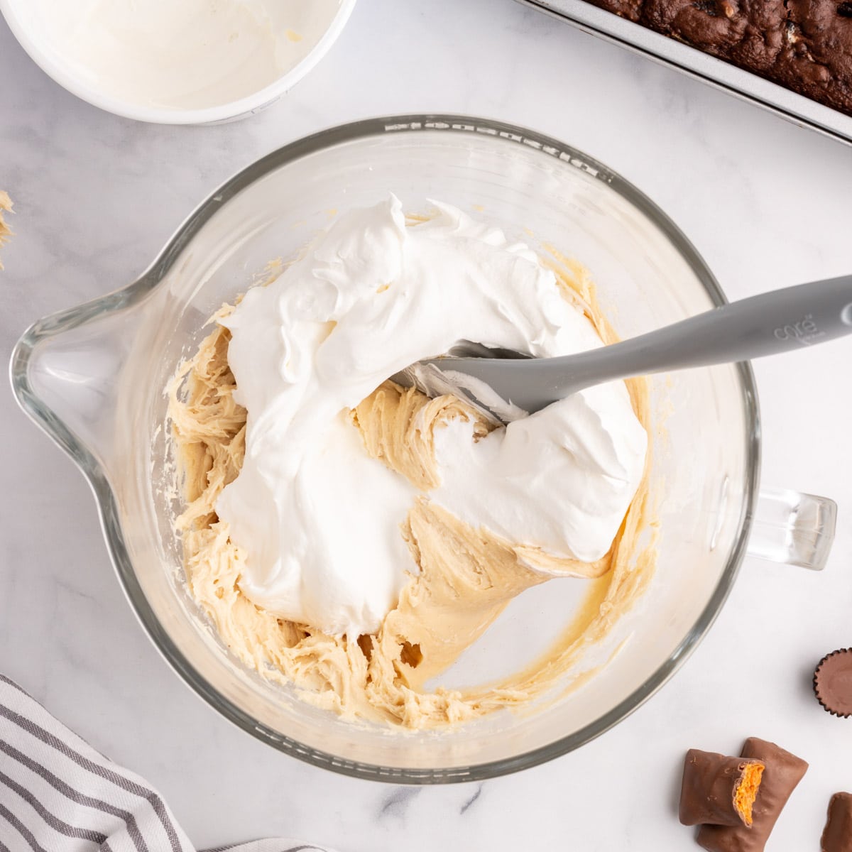 peanut butter cream and cool whip in a mixing bowl