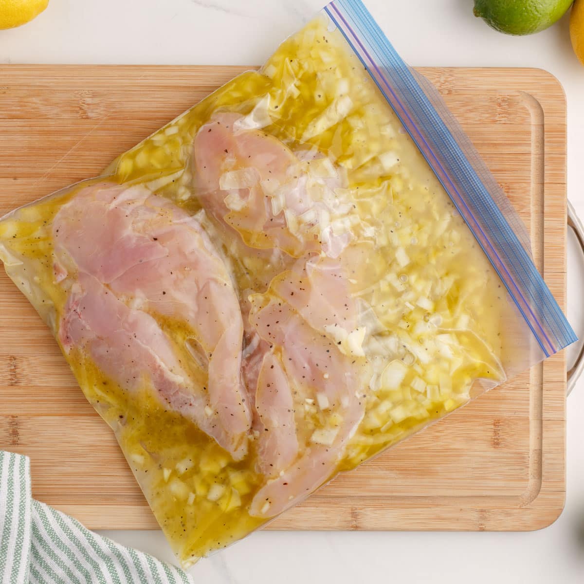 overhead view of chicken marinating in a bag