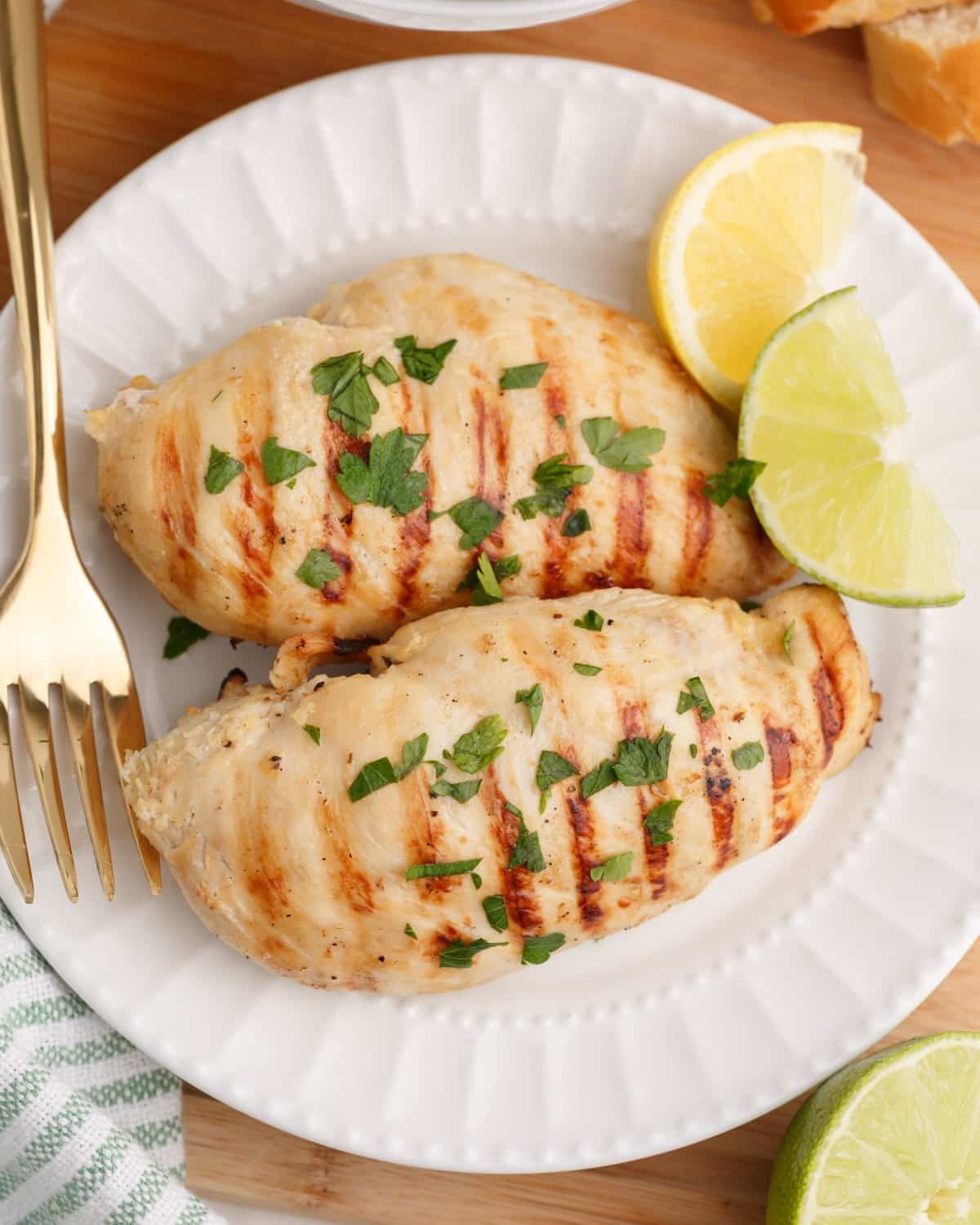 two pieces of grilled chicken on a plate