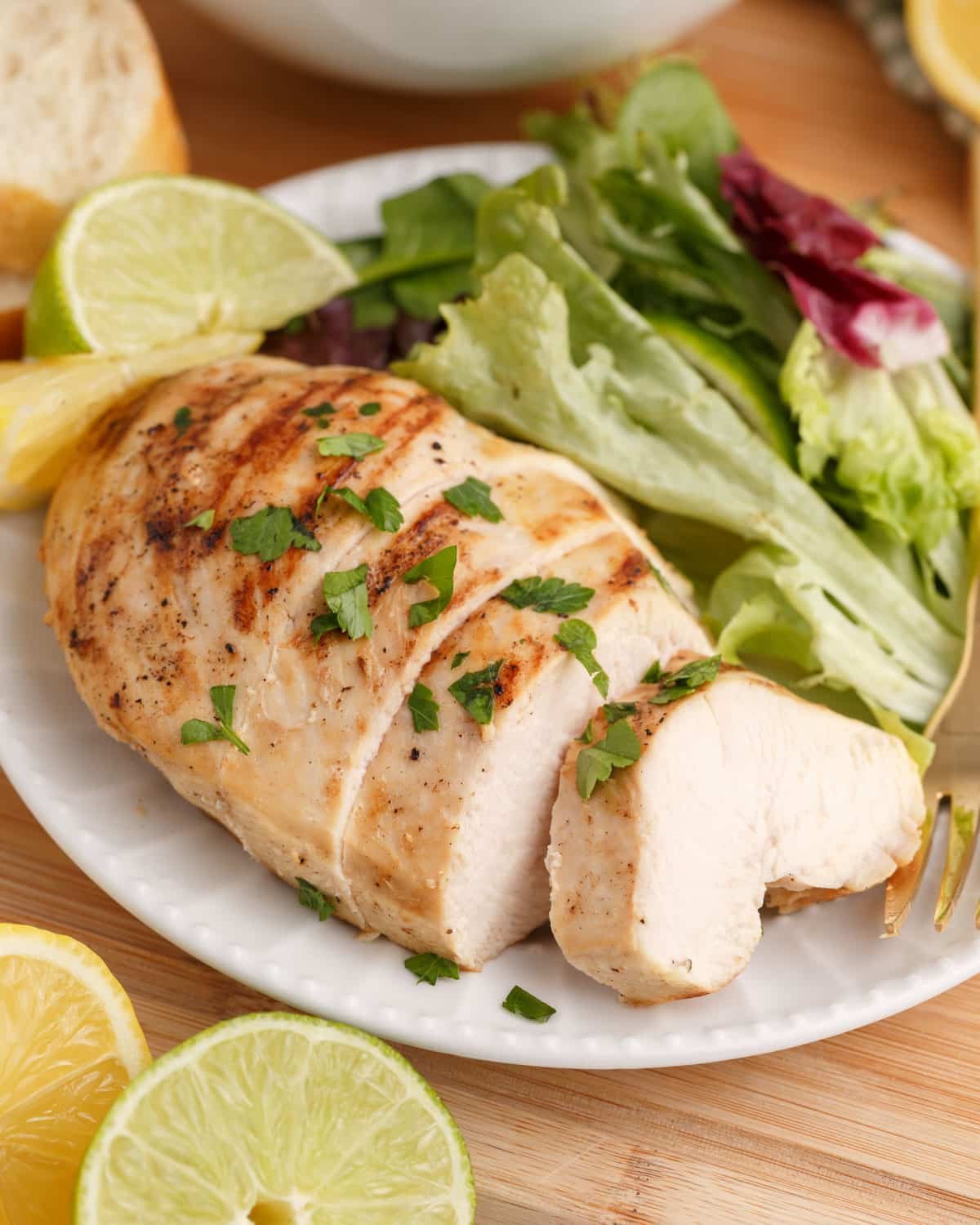 grilled lemon lime chicken on a plate with salad