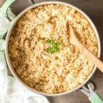 mexican white rice in a skillet with a wooden spoon