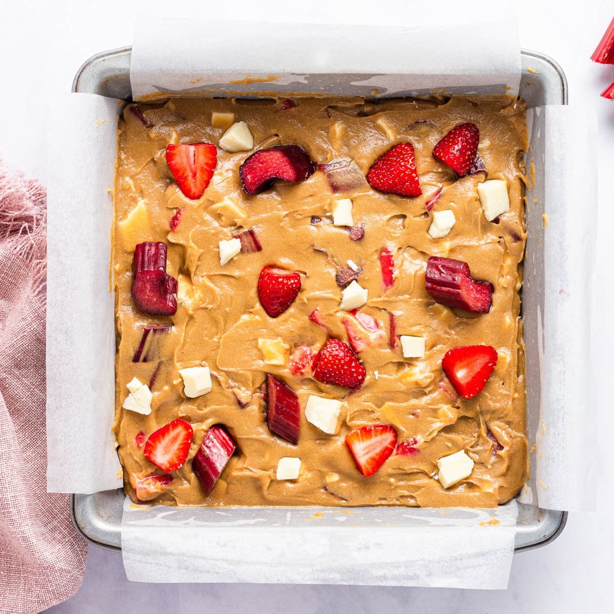 unbaked strawberry rhubarb blondies in a pan