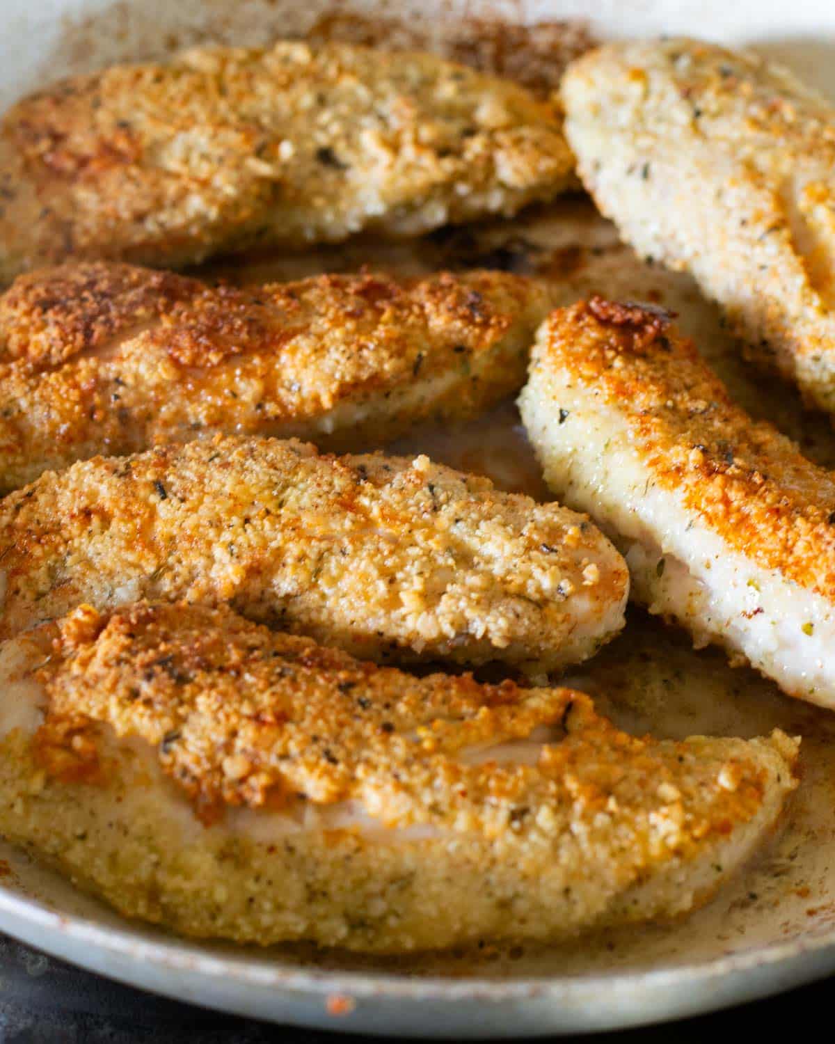 paleo chicken fingers in a frying pan