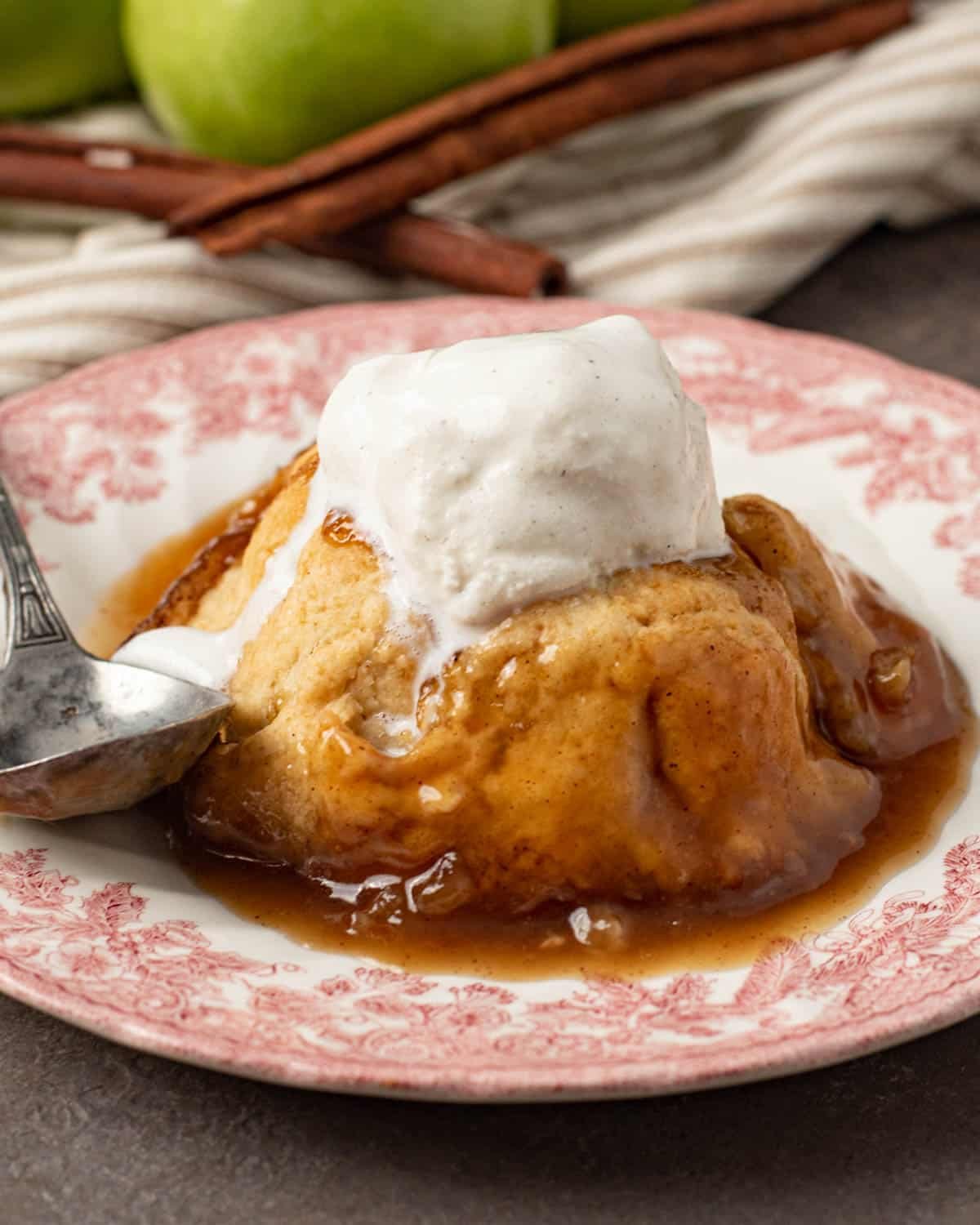 ice cream over an apple dumpling on a plate