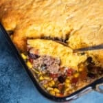 a spoon spooning out a scoop of tamale pie