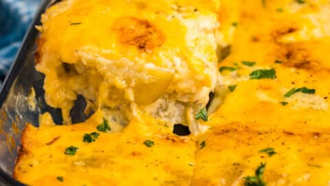 a spatula pulling out au gratin potatoes from a casserole