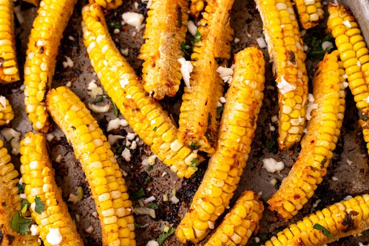 seasoned corn ribs on a baking sheet