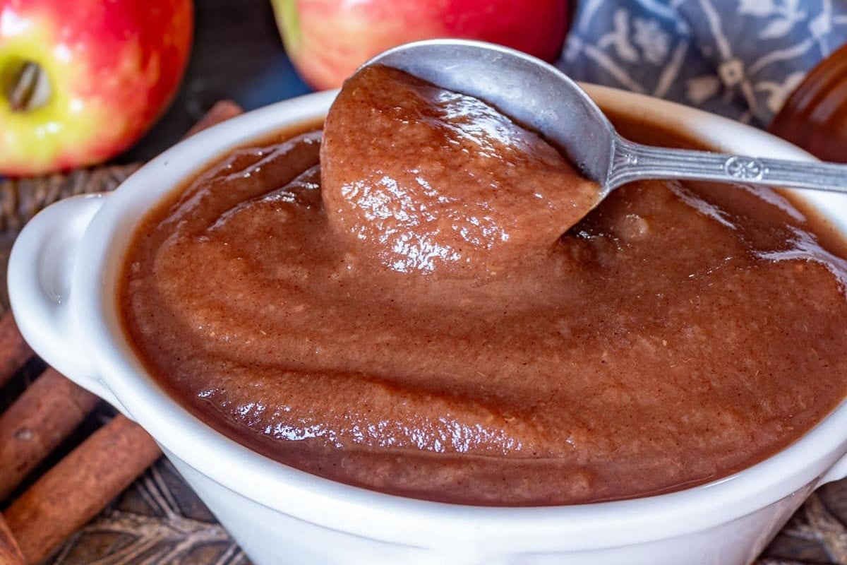 a bowl of apple butter with a spoon