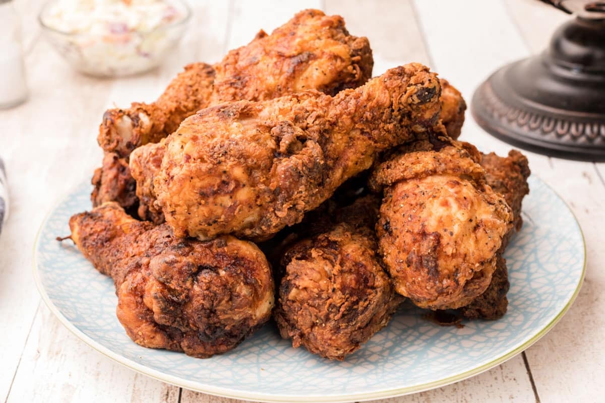 a plate of chicken fried drumsticks
