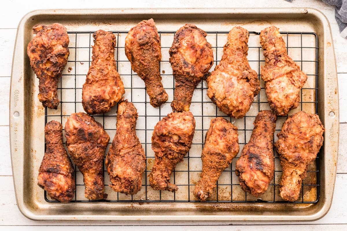 fried chicken drumsticks on a wire rack