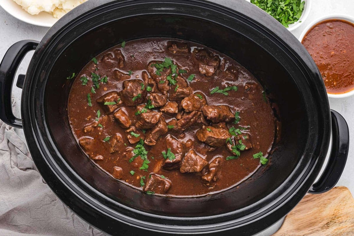 overhead view of beef tips in a crockpot