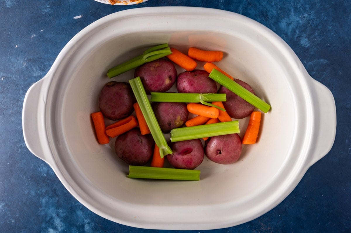 potatoes, carrots and celery in a slow cooker