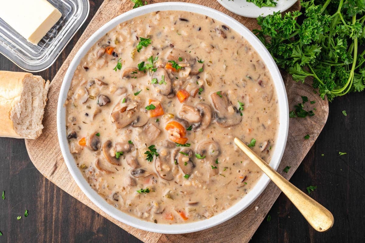 a bowl of wild rice mushroom soup on a table