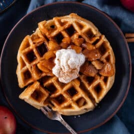 apple waffles with cinnamon apple syrup on a plate