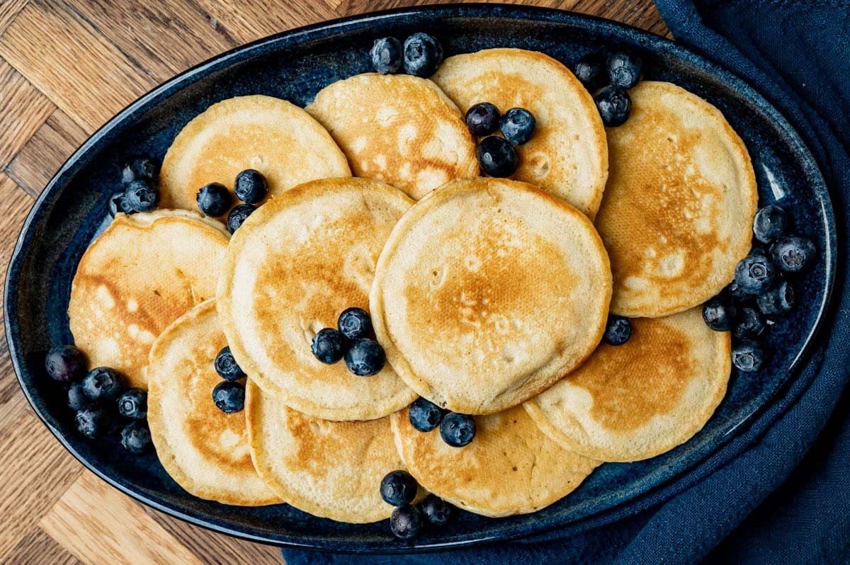 a plate of homemade pancakes and blueberries