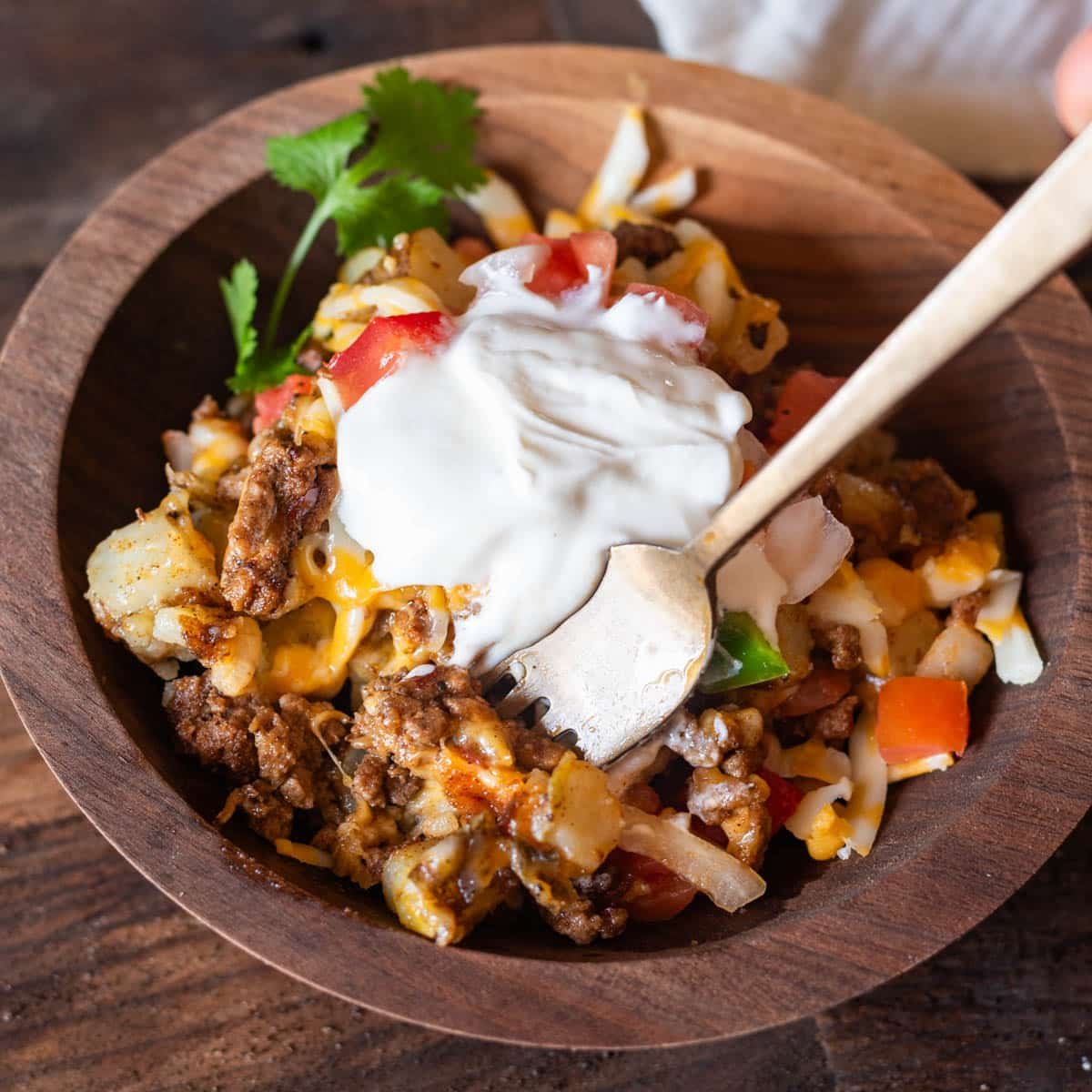 a bowl of mexican potatoes with taco toppings