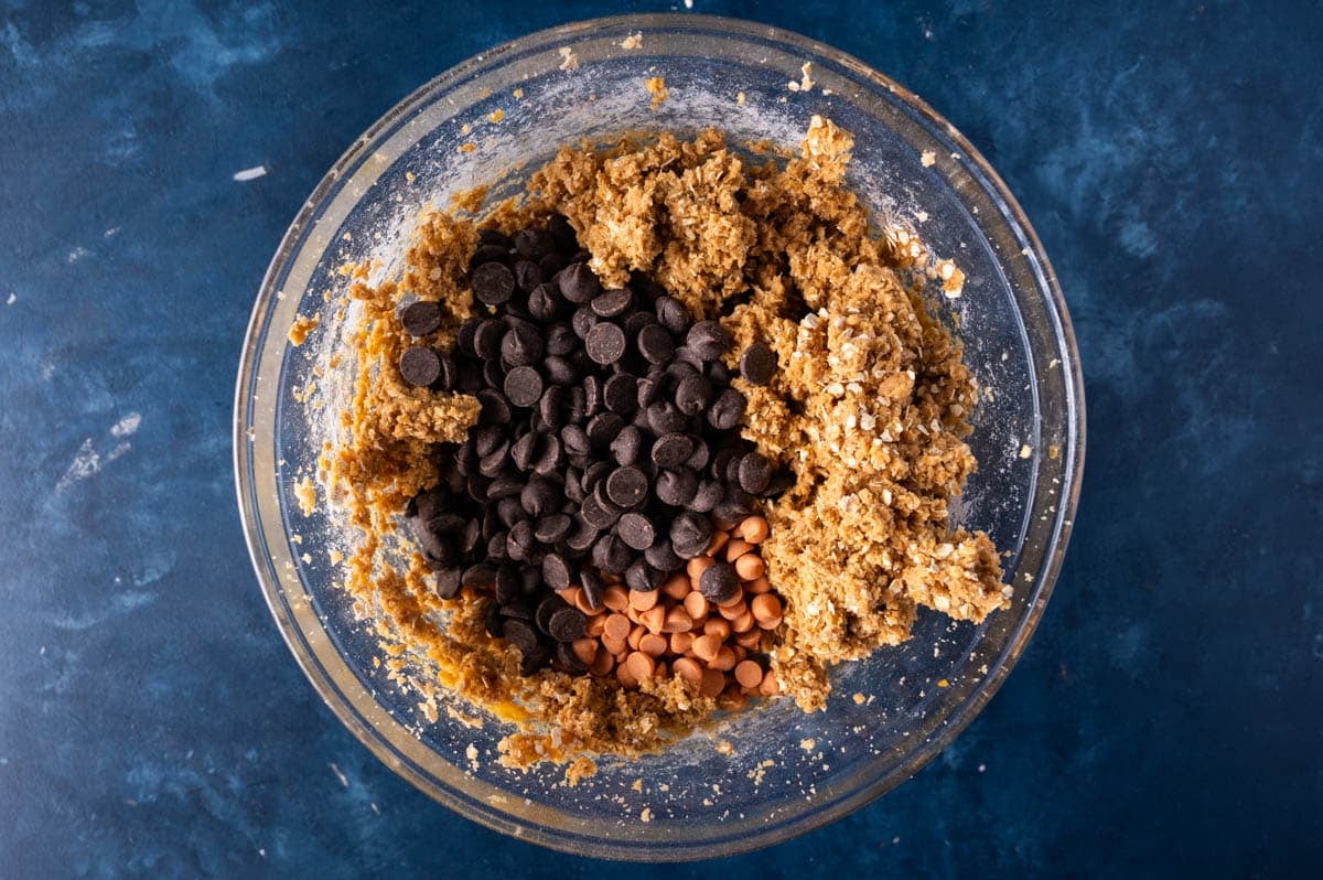 cookie dough in a bowl with baking chips on top