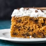 a piece of pumpkin poke cake with chocolate chips on a plate