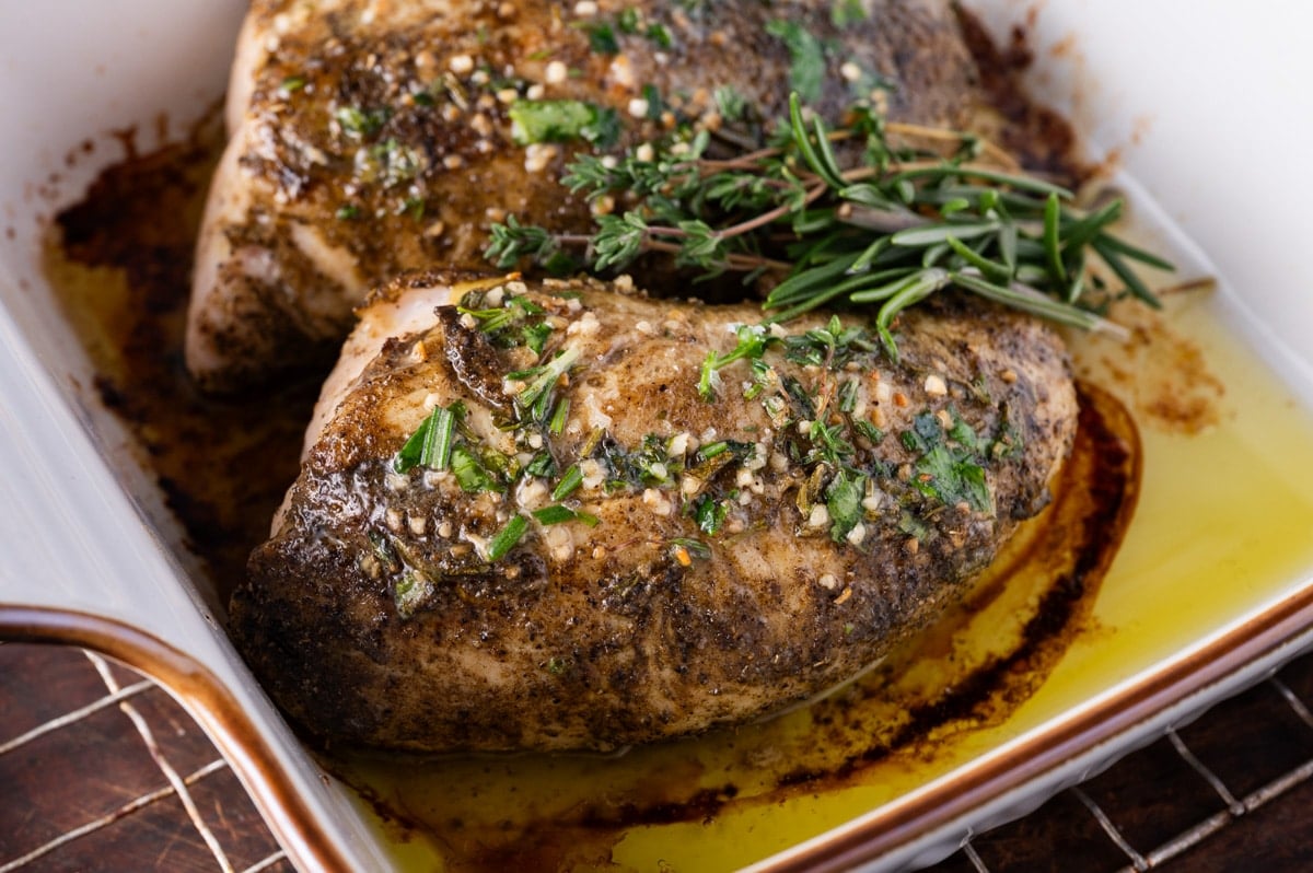 turkey tenderloin roasted in a baking pan with garlic butter and fresh herbs
