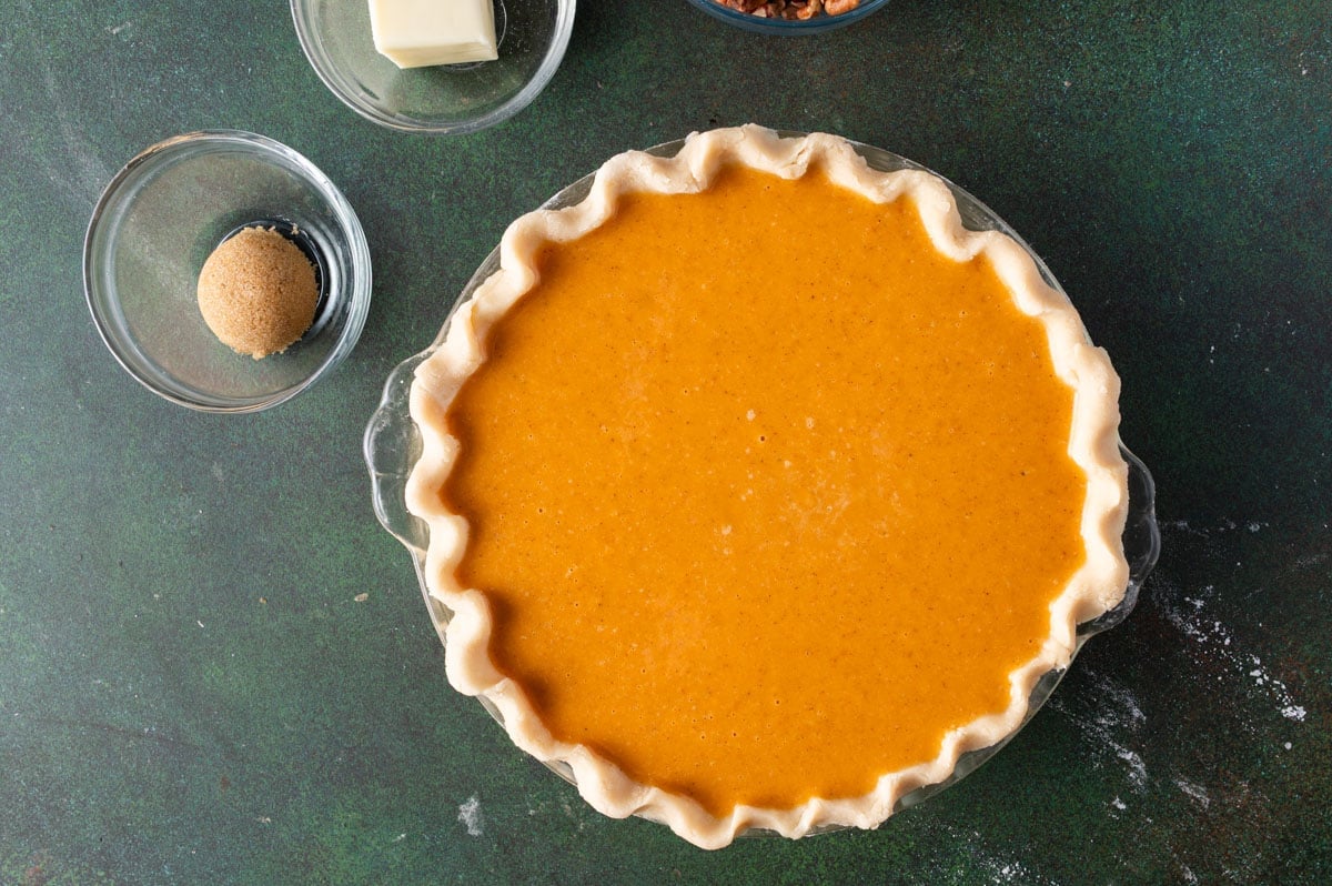 unbaked pumpkin pie on a table