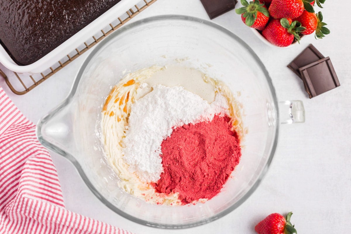 ingredients for strawberry frosting in a bowl